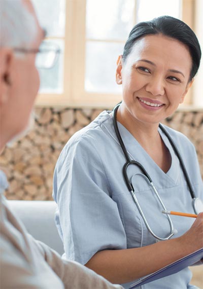 Friendly nurse speaking with senior man Friendly nurse speaking with senior man