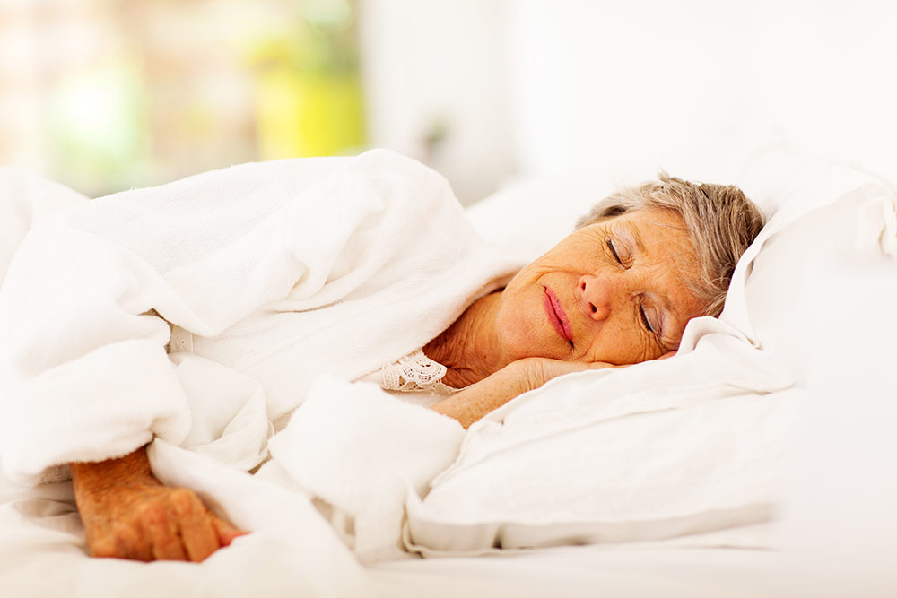 Senior woman sleeping peacefully in bed