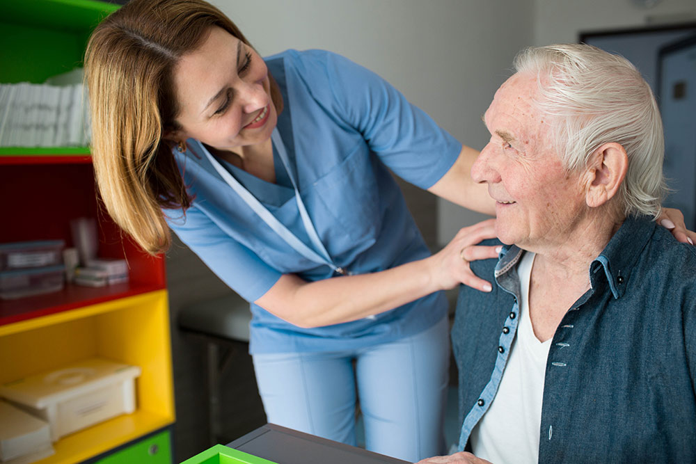 Senior man with caregiver in assisted living community