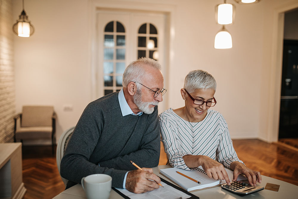 Senior couple going over expenses and budgeting for retirement