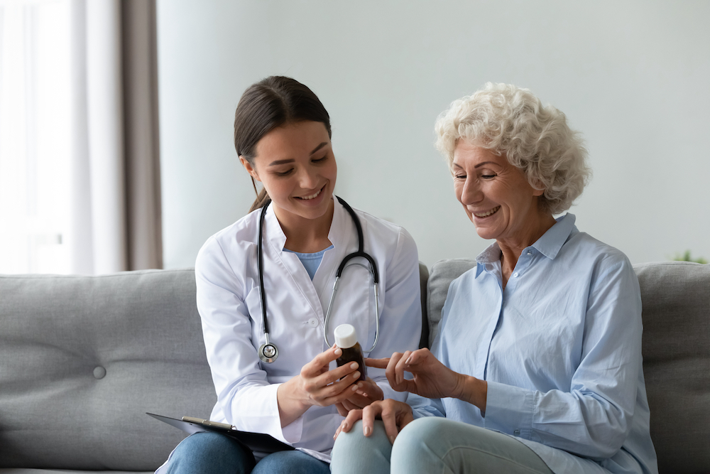 A senior woman and her doctor discuss taking vitamins