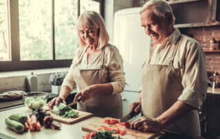 A senior couple prepares a healthy meal together