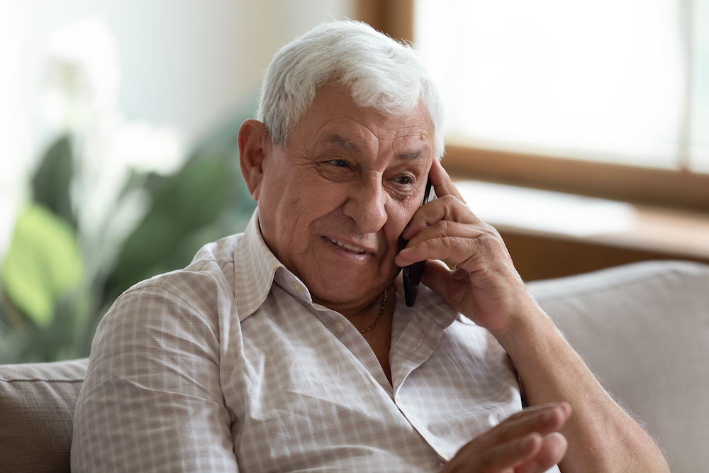 A senior man talking on the phone at memory care in Palm Springs