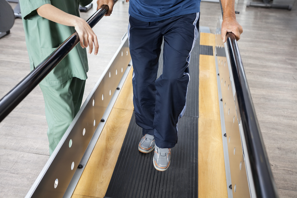 A senior man undergoes physical therapy