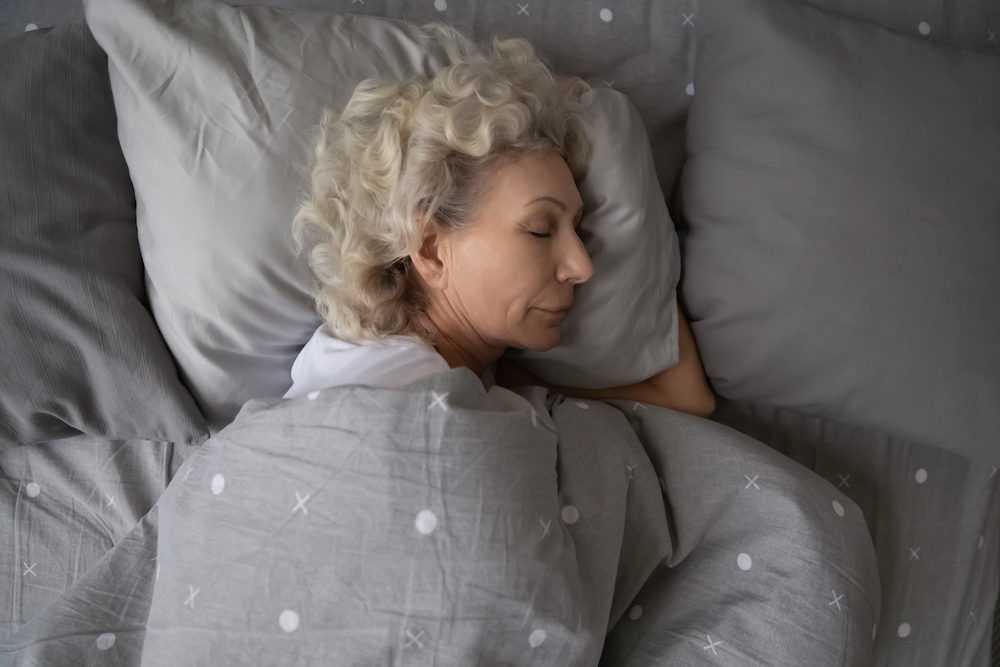 A senior woman asleep in bed
