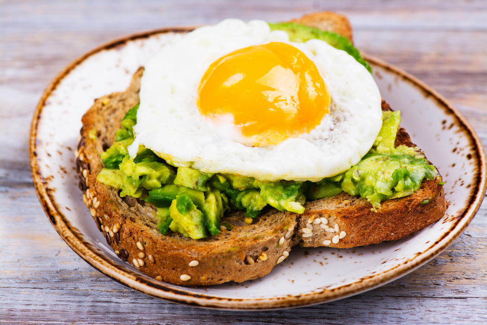 A fried egg on a slice of avocado toast