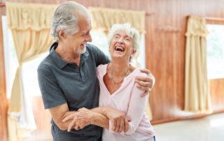 A joyful senior couple laughing and having fun at their Palm Springs senior living community