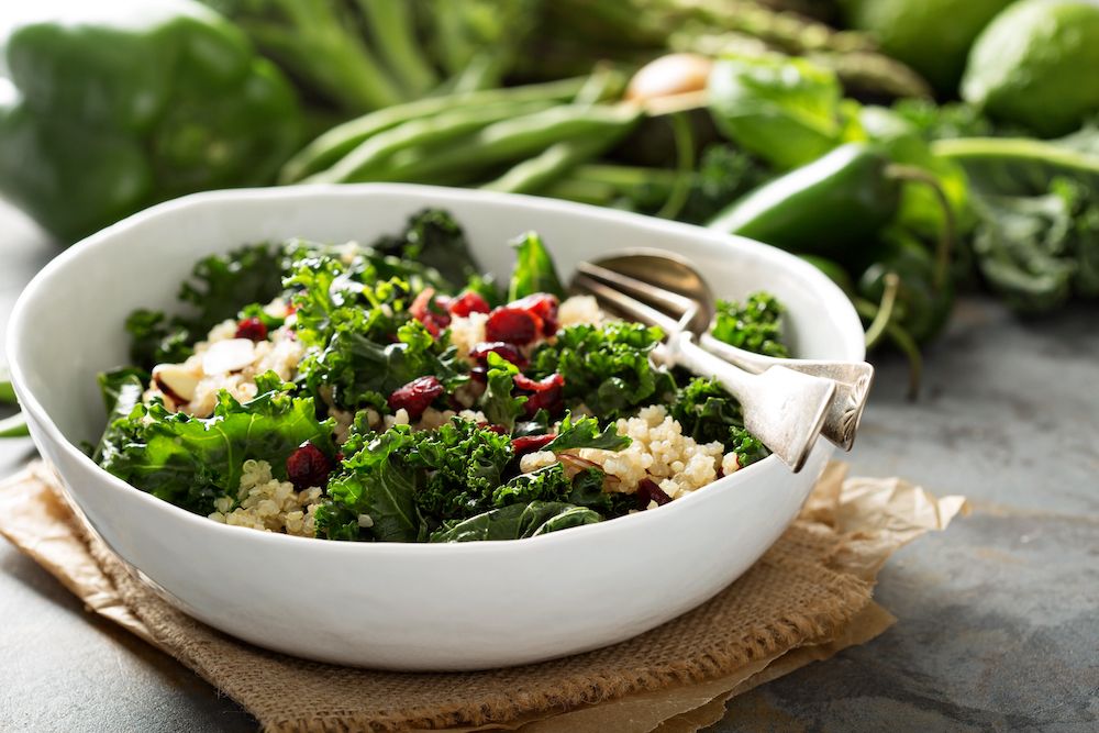 A healthy bowl of kale salad with other veggies