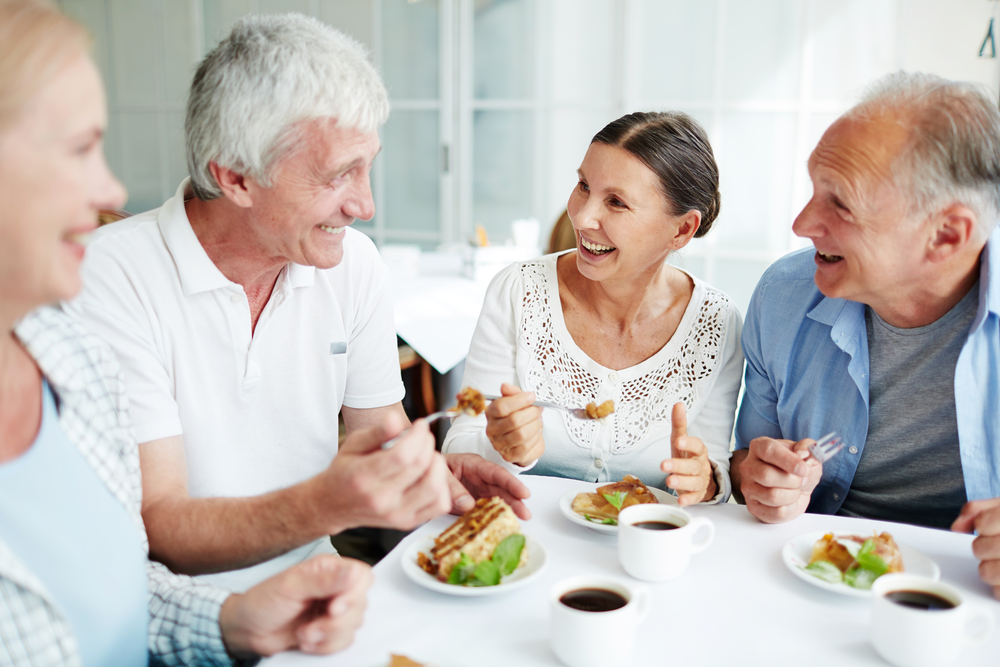 Group of senior friends enjoying a meal in senior living rancho mirage ca