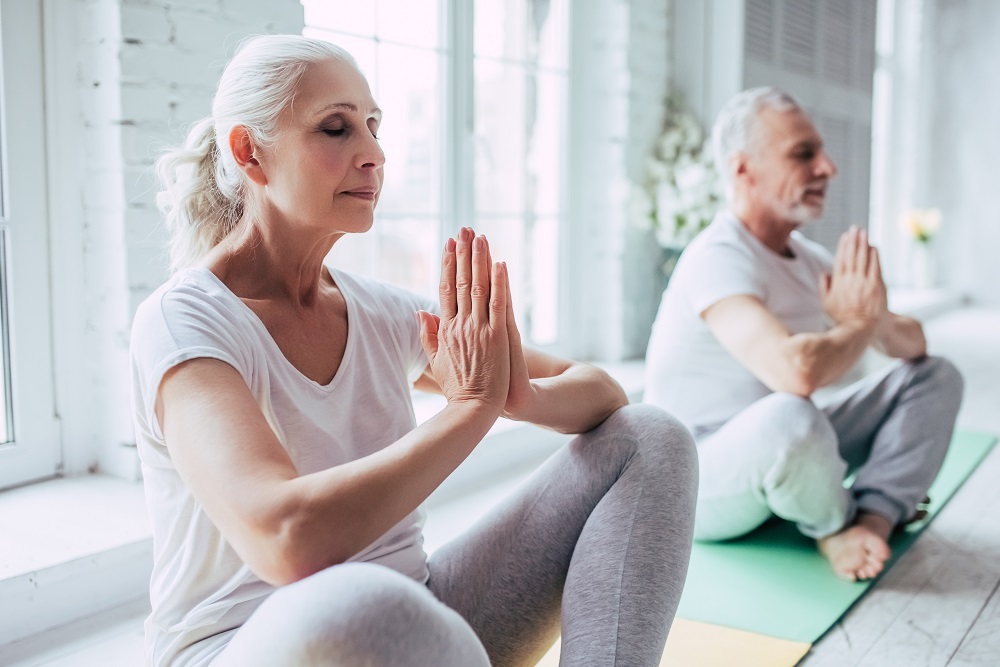 A senior woman practicing mindfulness yoga