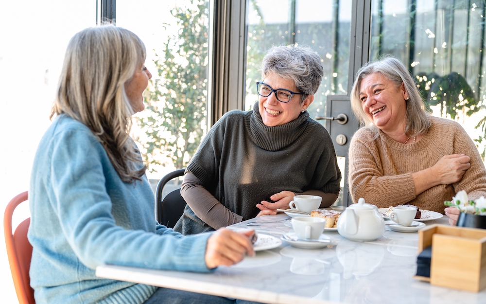 Three senior friends enjoying coffee at independent living i Rancho Mirage