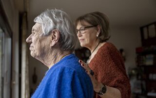 Senior woman and adult daughter standing together discussing memory care rancho mirage