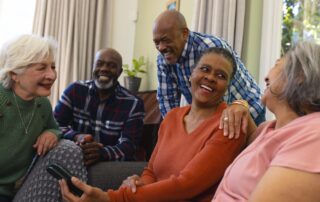 Group of seniors sitting together inside and enjoying rancho mirage retirement communities