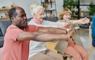 Group of seniors doing exercises together at their memory care rancho mirage